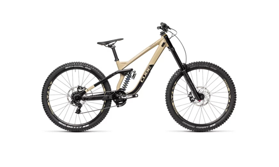 A beige and black mountain bike with thick tires and a full suspension system. The design looks robust, suggesting durability and off-road capability.