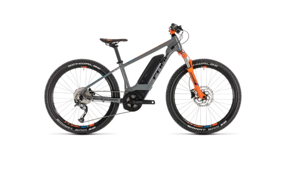 A sleek, gray electric mountain bike with orange accents, featuring wide tires and rugged frame, designed for off-road cycling adventures.